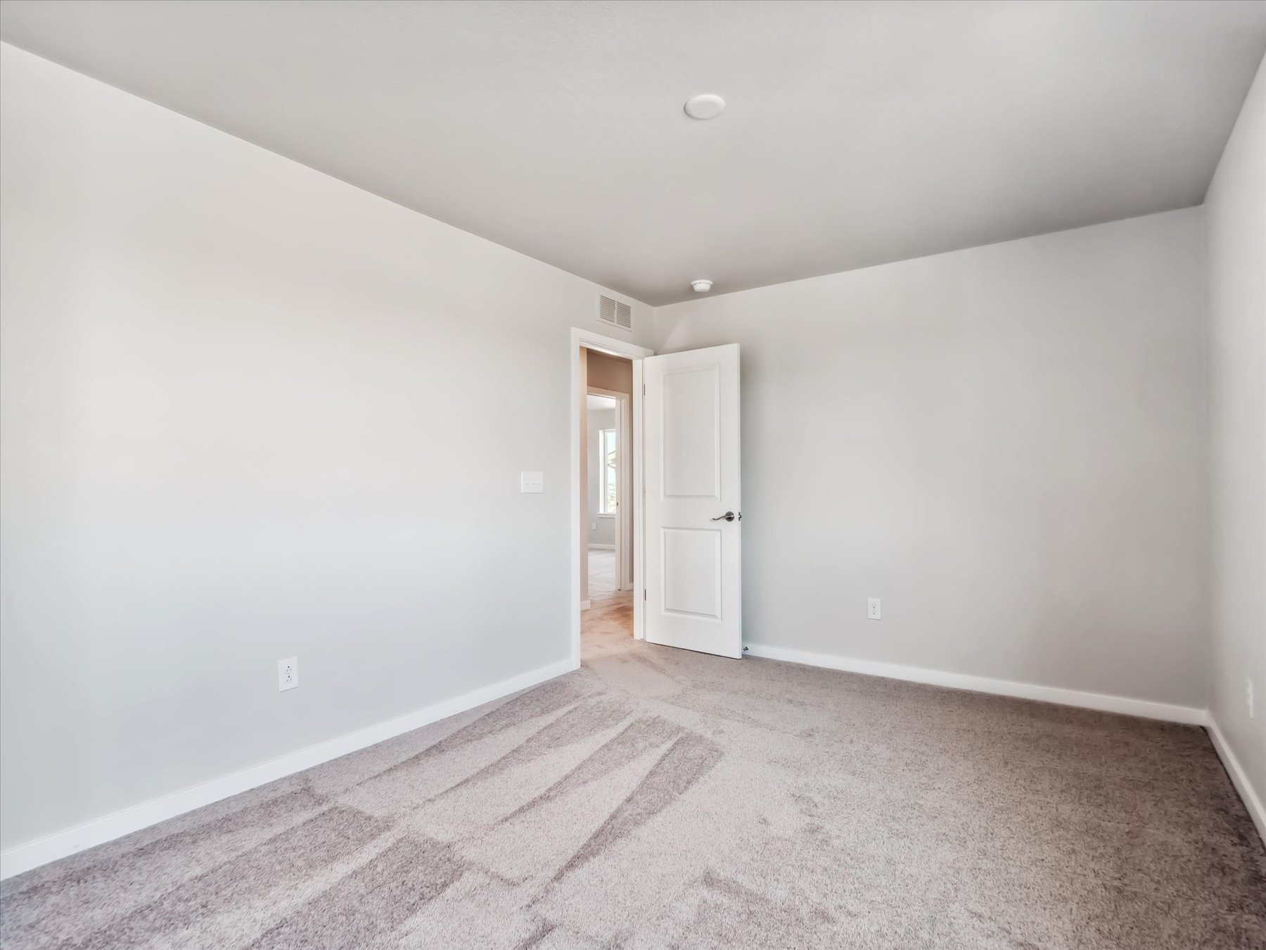 A hallway with white walls.