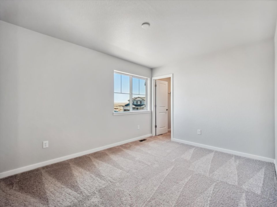 A room with a window and a door.