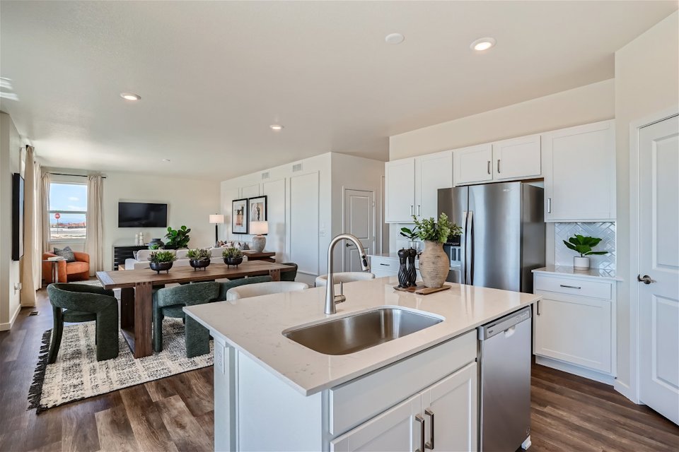 A kitchen with white cabinets.