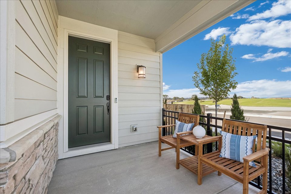 A patio with chairs and a table.