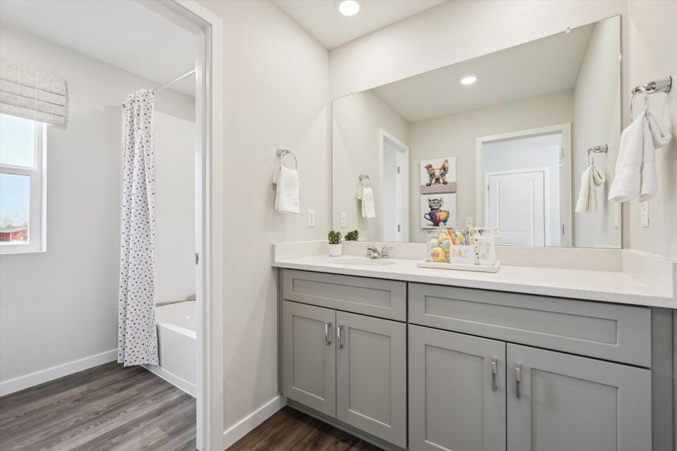 A bathroom with a shower and sink.