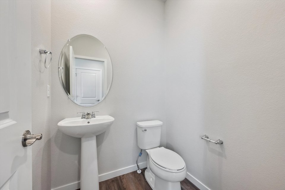 A bathroom with a toilet and sink.