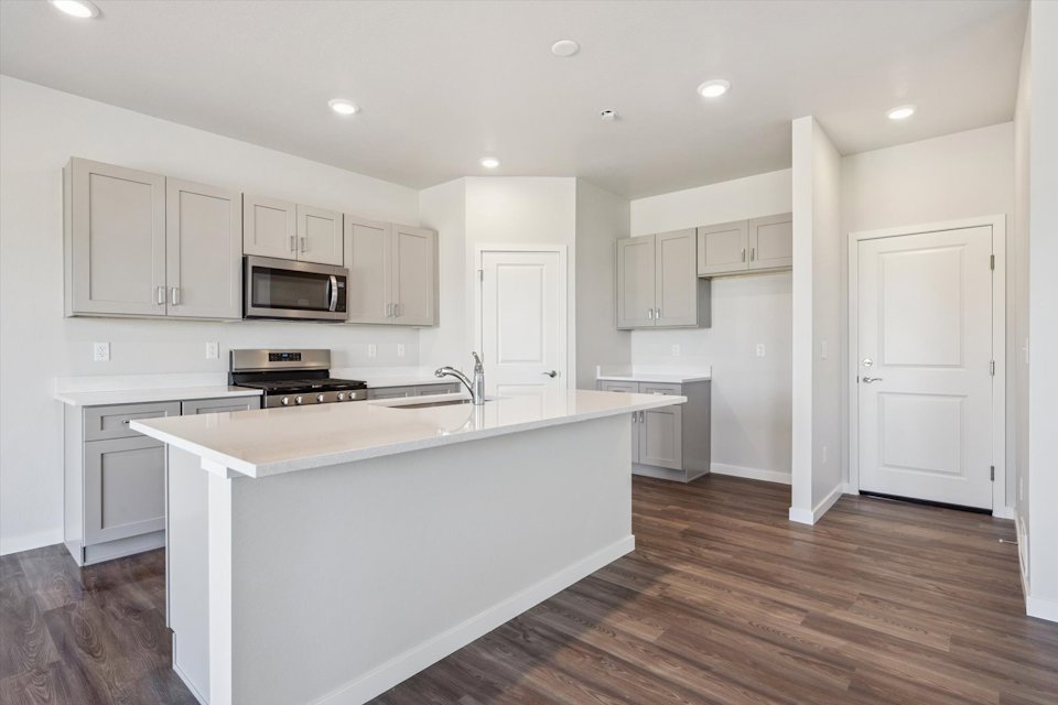 A kitchen with white cabinets.
