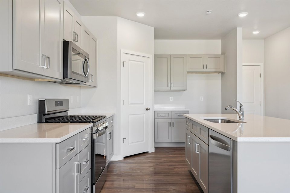 A kitchen with white cabinets.