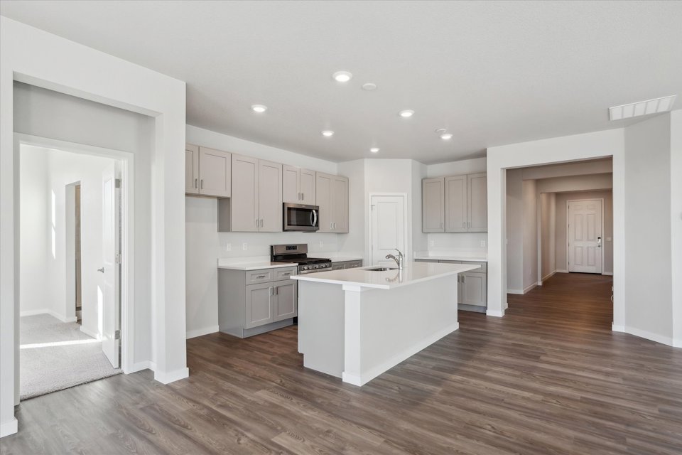 A kitchen with white cabinets.