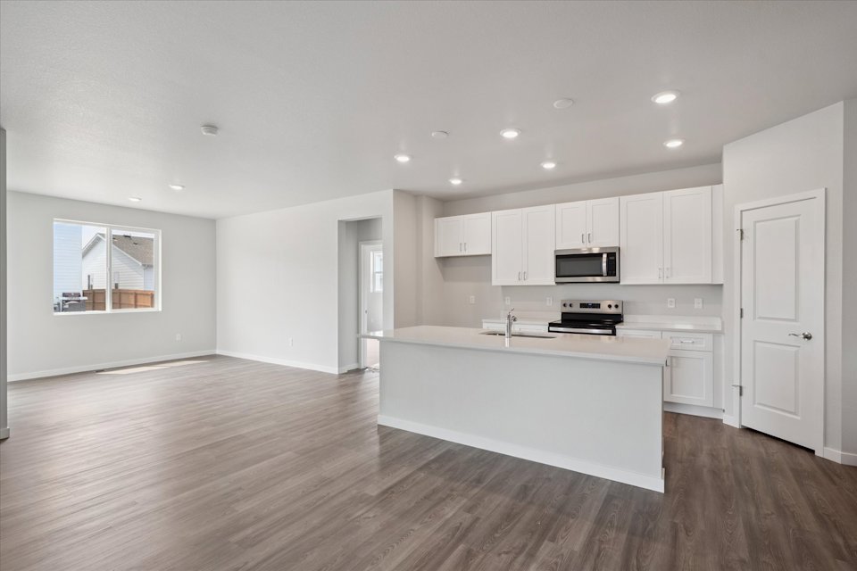 A kitchen with white cabinets.