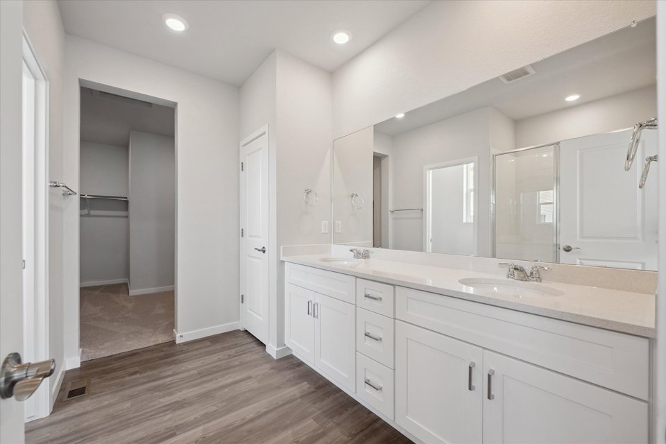 A bathroom with white cabinets.