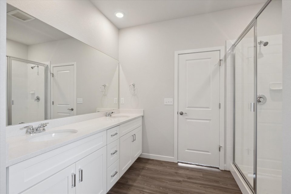 A bathroom with a shower and sink.