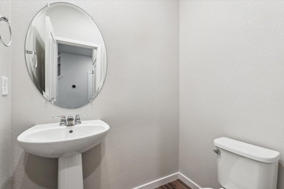 A bathroom with a mirror and sink.