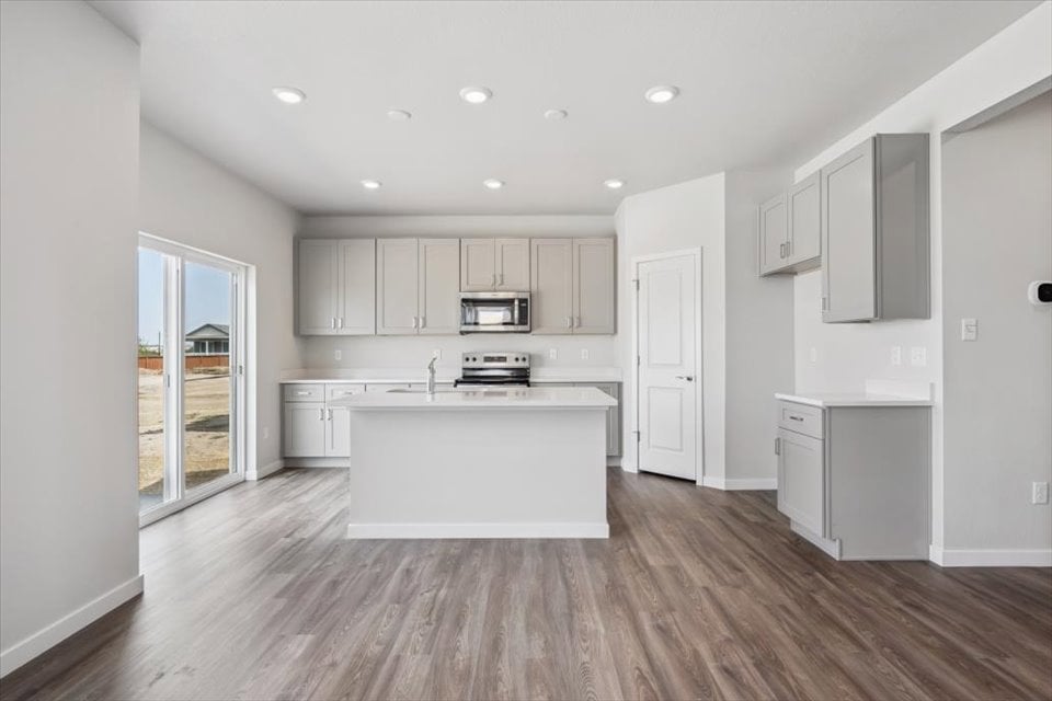 A kitchen with white cabinets.