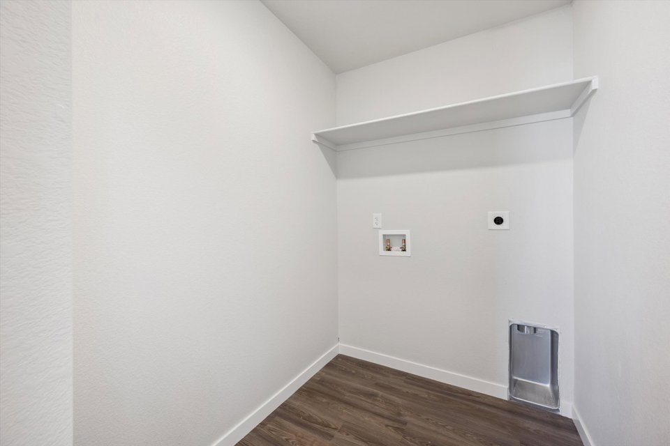 A white room with a wood floor.