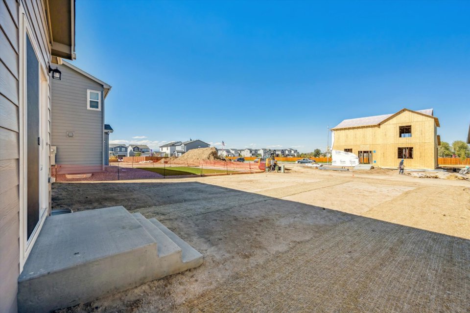 A concrete area with buildings in the background.