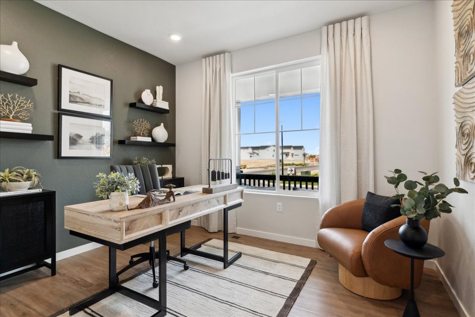 A living room with a table and chairs.