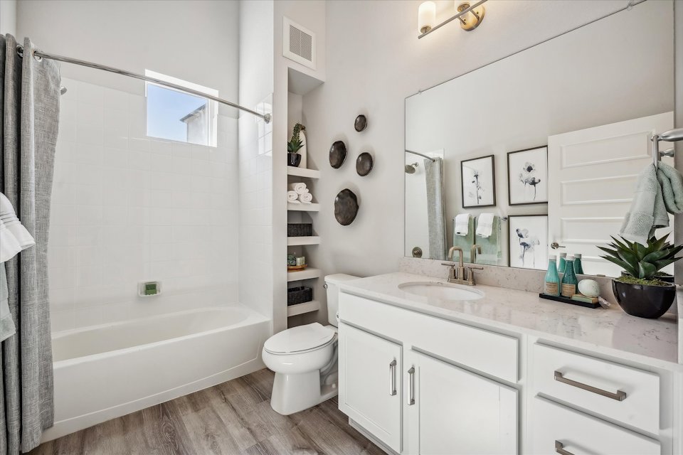 A bathroom with a tub toilet and sink.