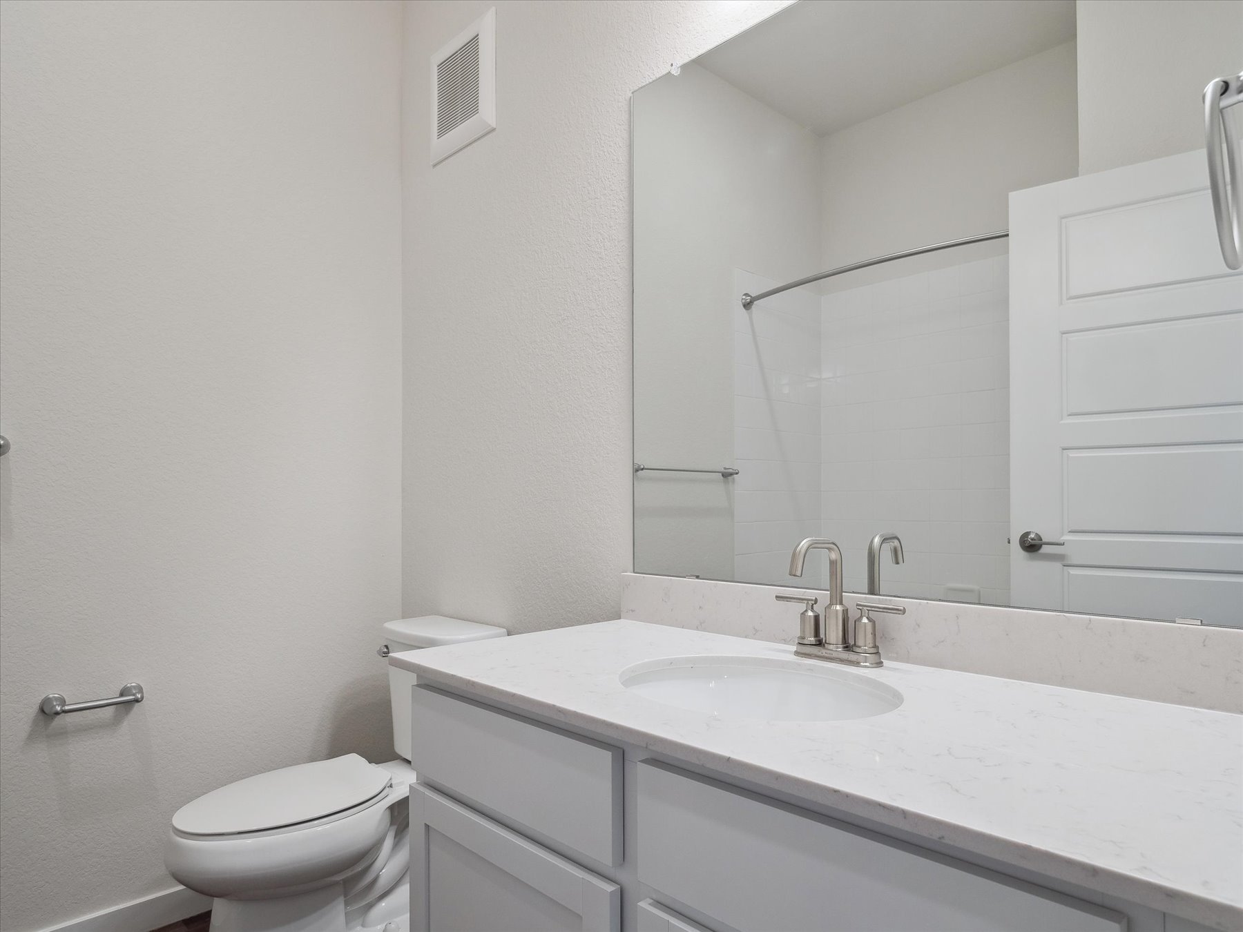 A bathroom with a sink and a toilet.