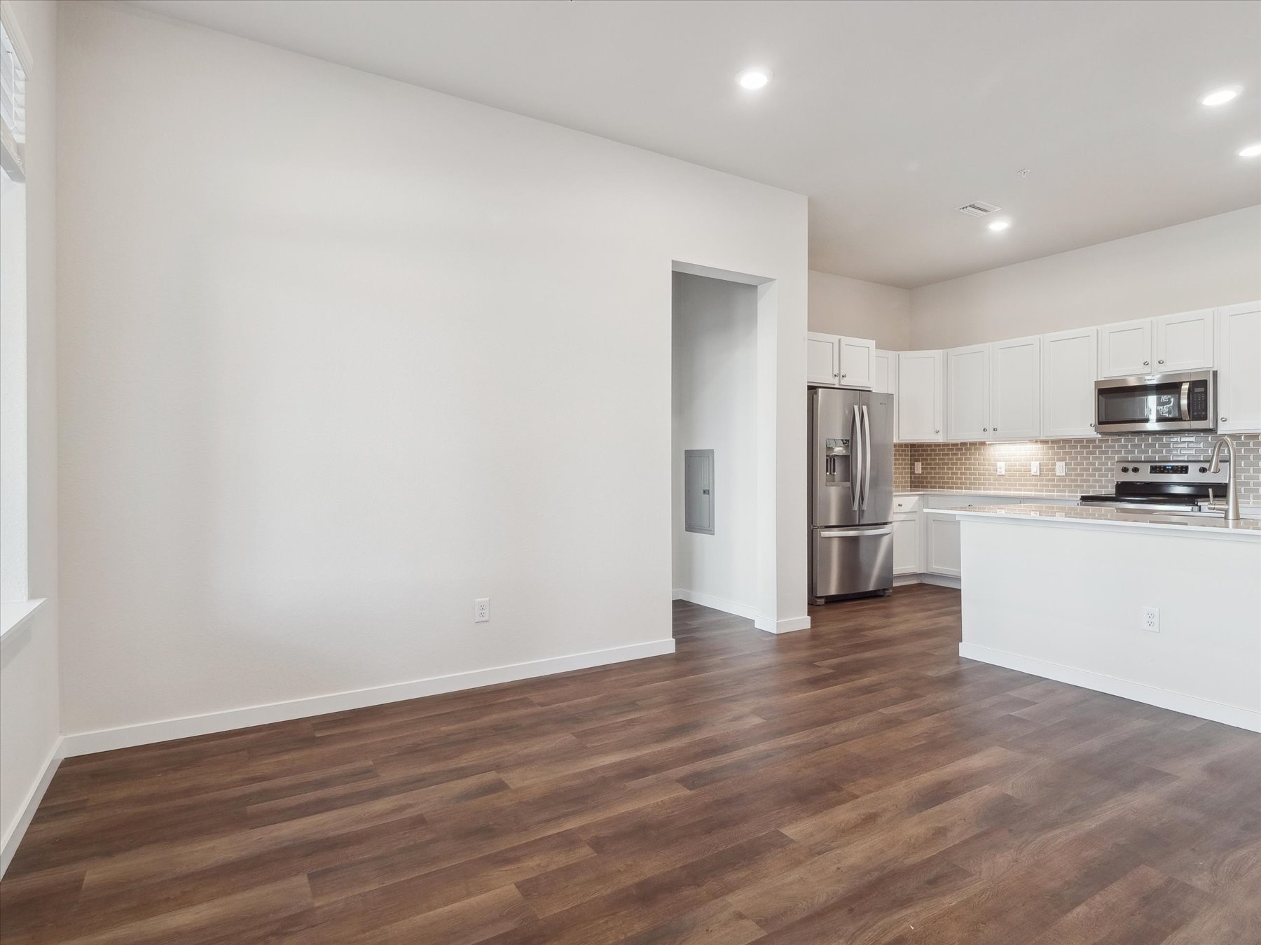 A kitchen with white walls.