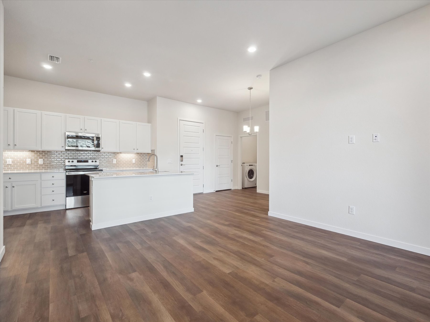 A kitchen with white cabinets.