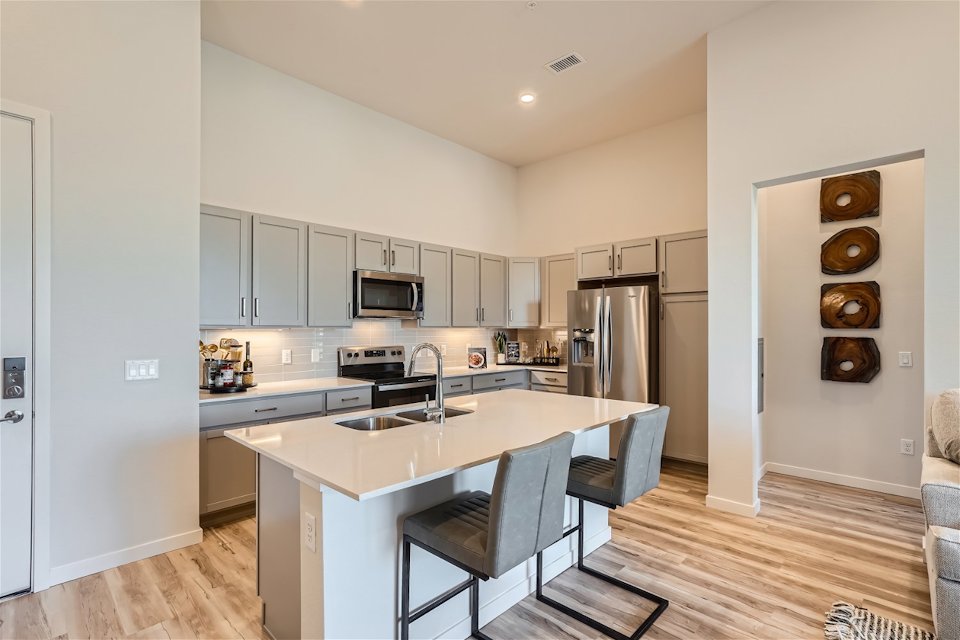 A kitchen with a table and chairs.