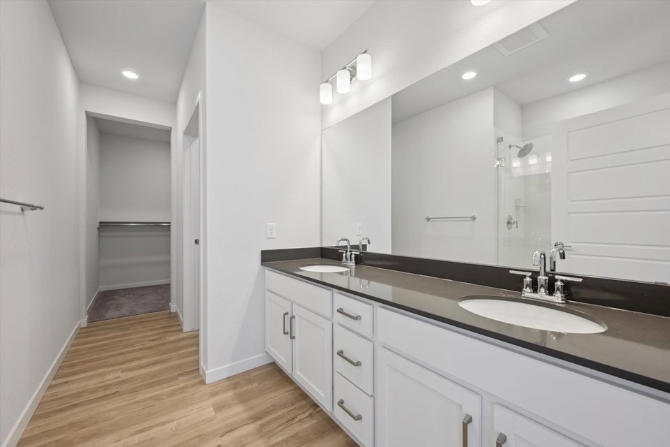 A bathroom with a large mirror.