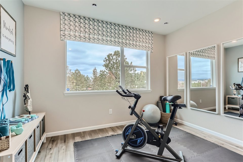A room with a bike and a window.