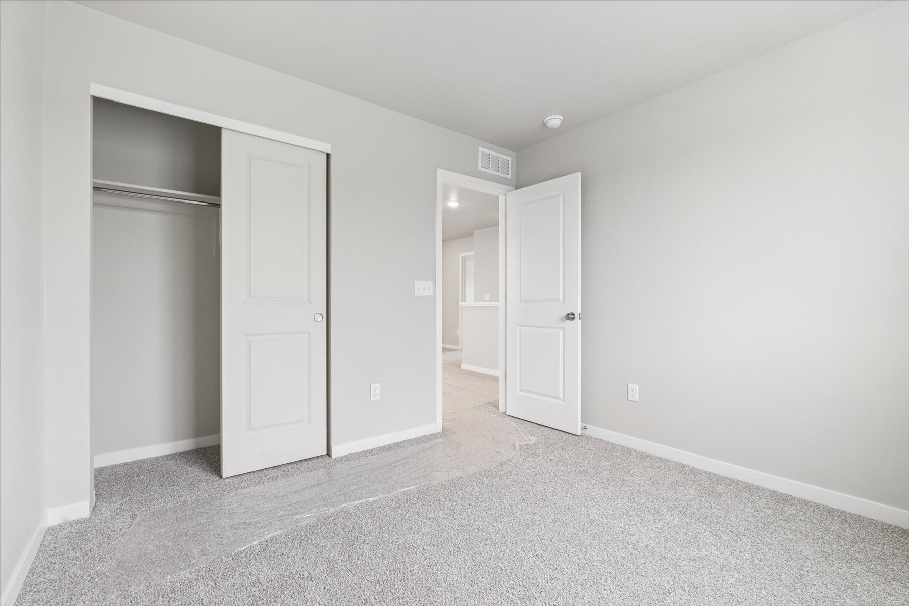 A hallway with white doors.
