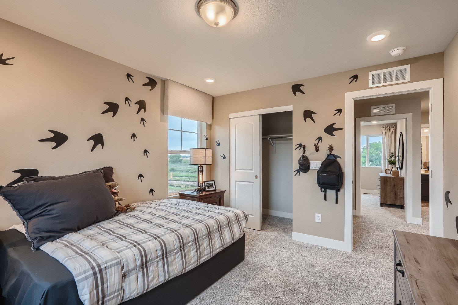 A bedroom with a bed and a table.