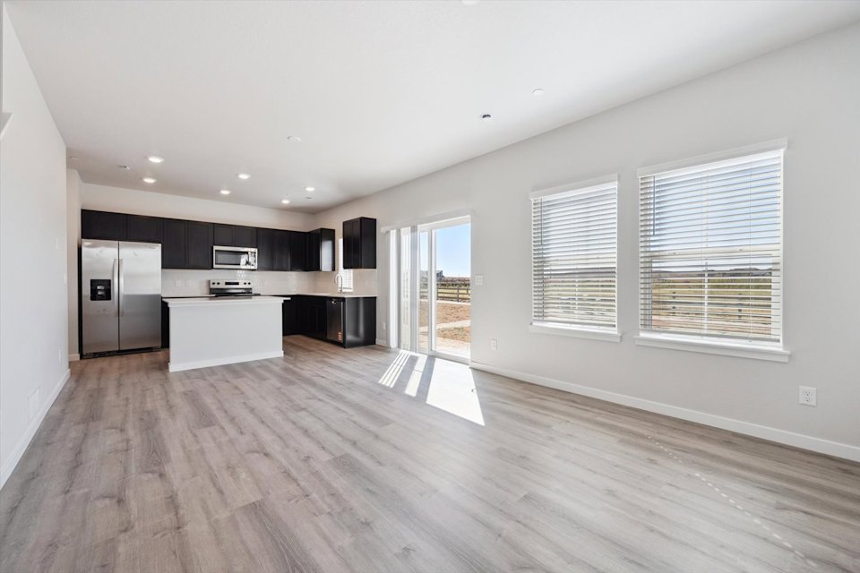A kitchen with black cabinets.