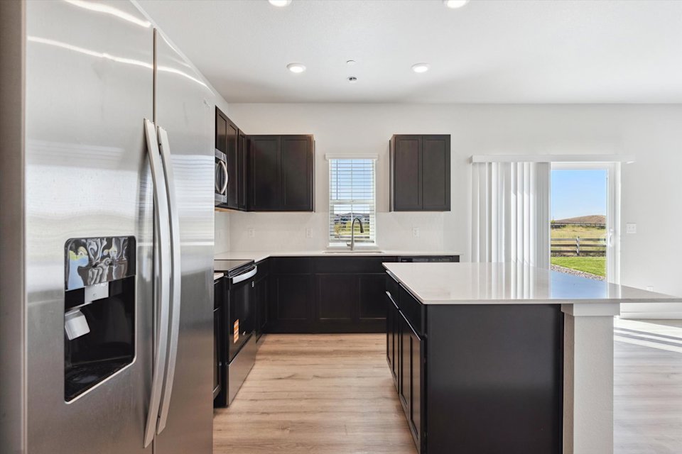 A kitchen with black appliances.