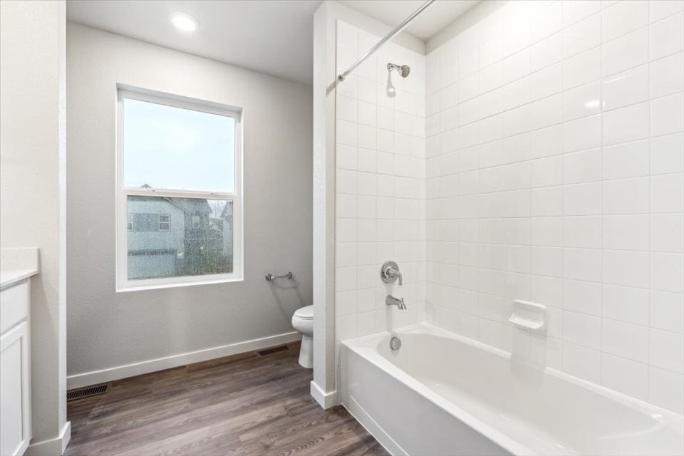 A bathroom with a tub toilet and sink.