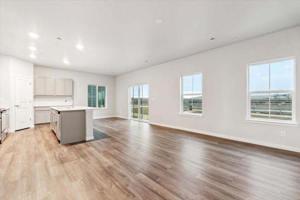 A large empty room with white cabinets.