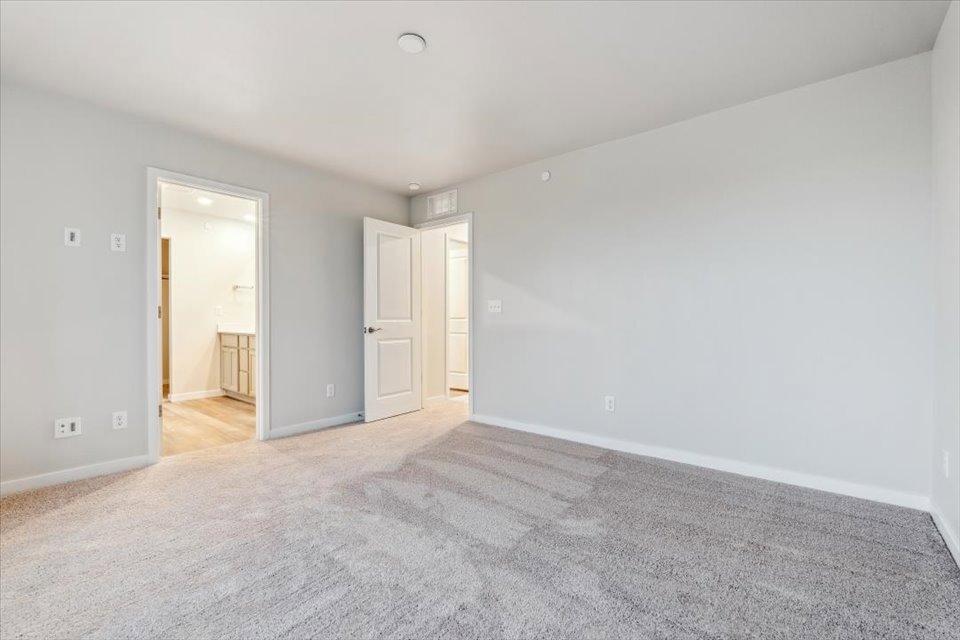A long hallway with white walls.