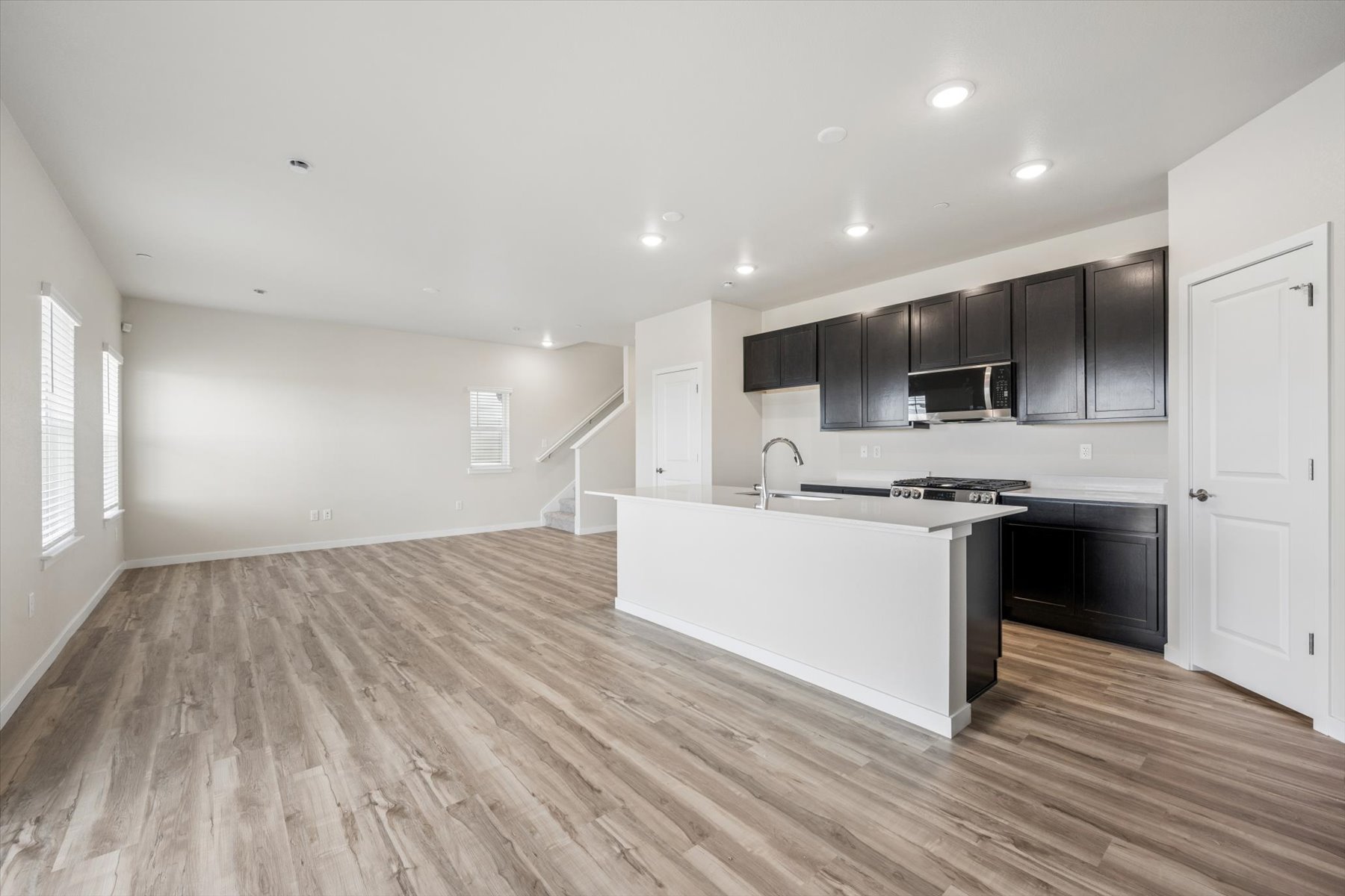 A kitchen with black cabinets.