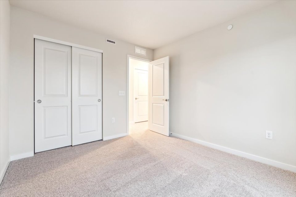 A hallway with white doors.