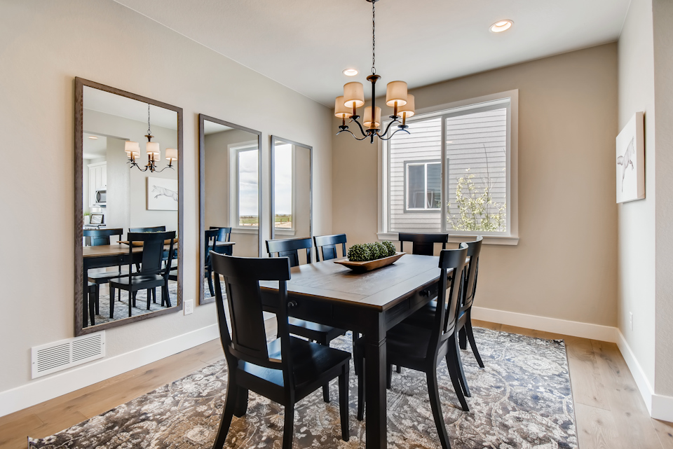 A dining room table with chairs.