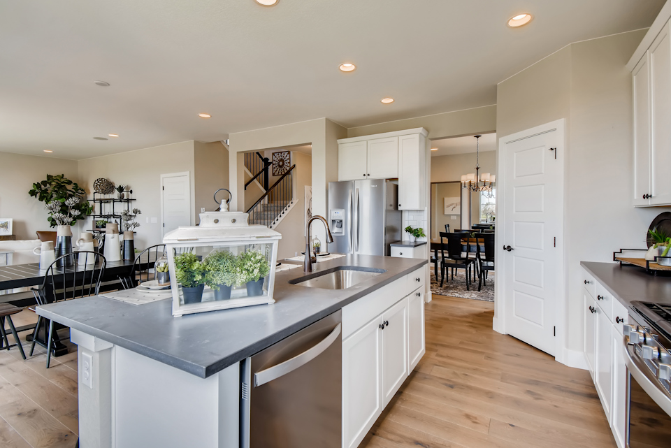 A kitchen with white cabinets.