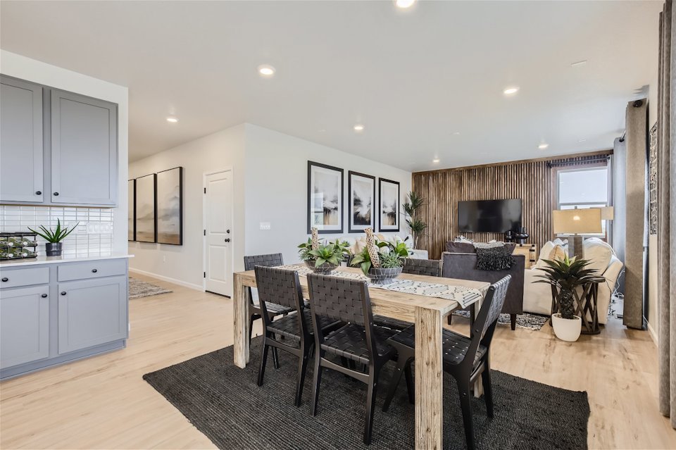 A dining room with a table and chairs.