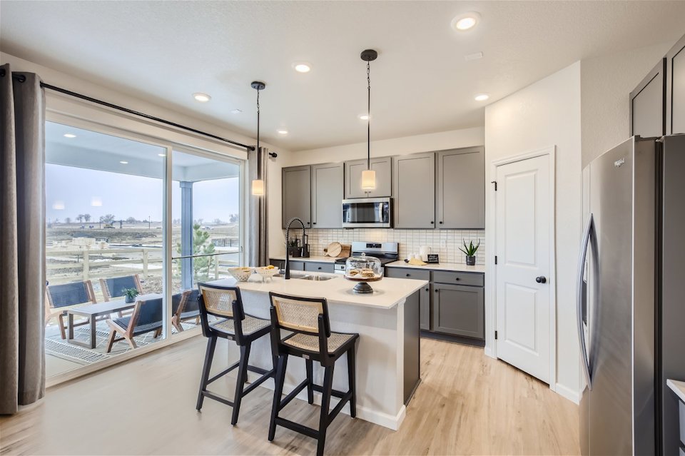 A kitchen with a table and chairs.