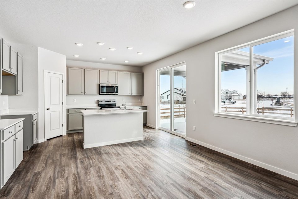 A kitchen with a large window.
