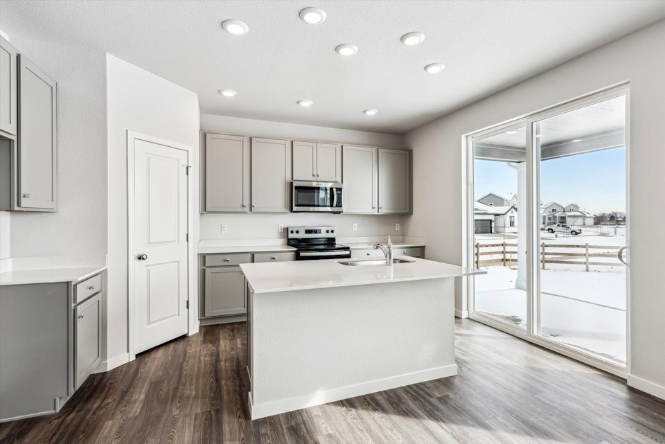 A kitchen with white cabinets.