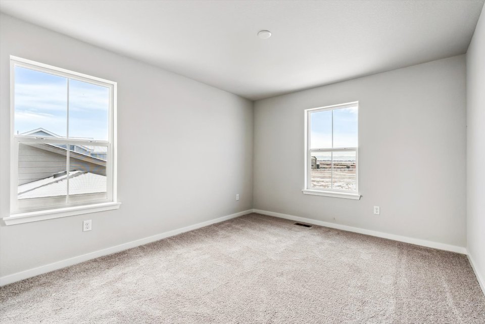A room with a window and a carpet.