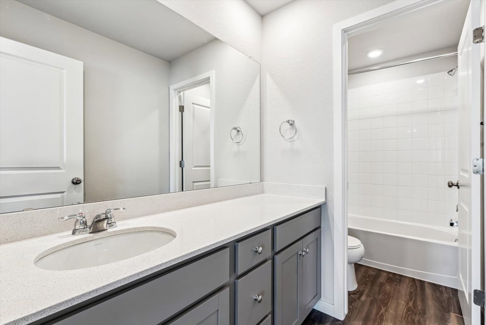 A bathroom with a sink and a toilet.