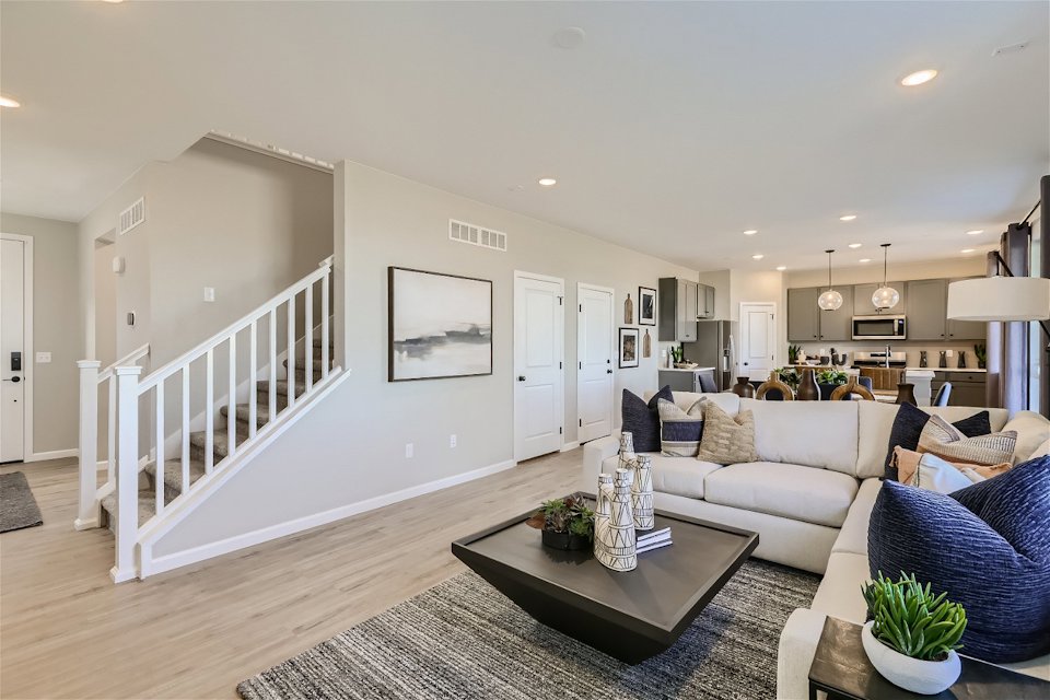 A living room with a white staircase.