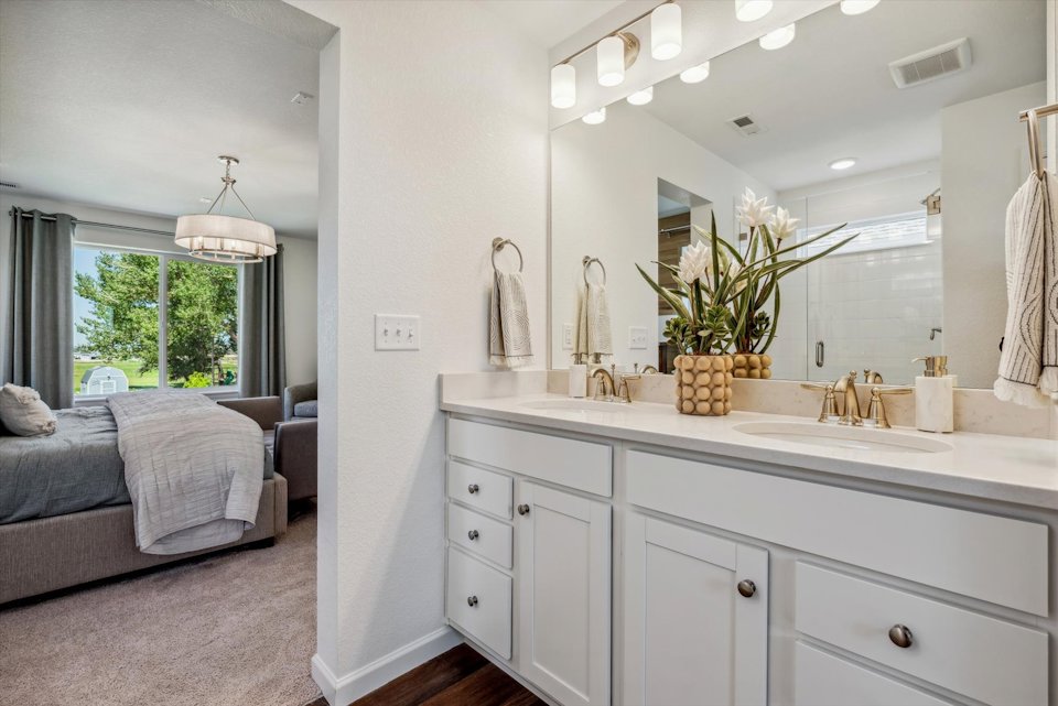 A bathroom with a large mirror.