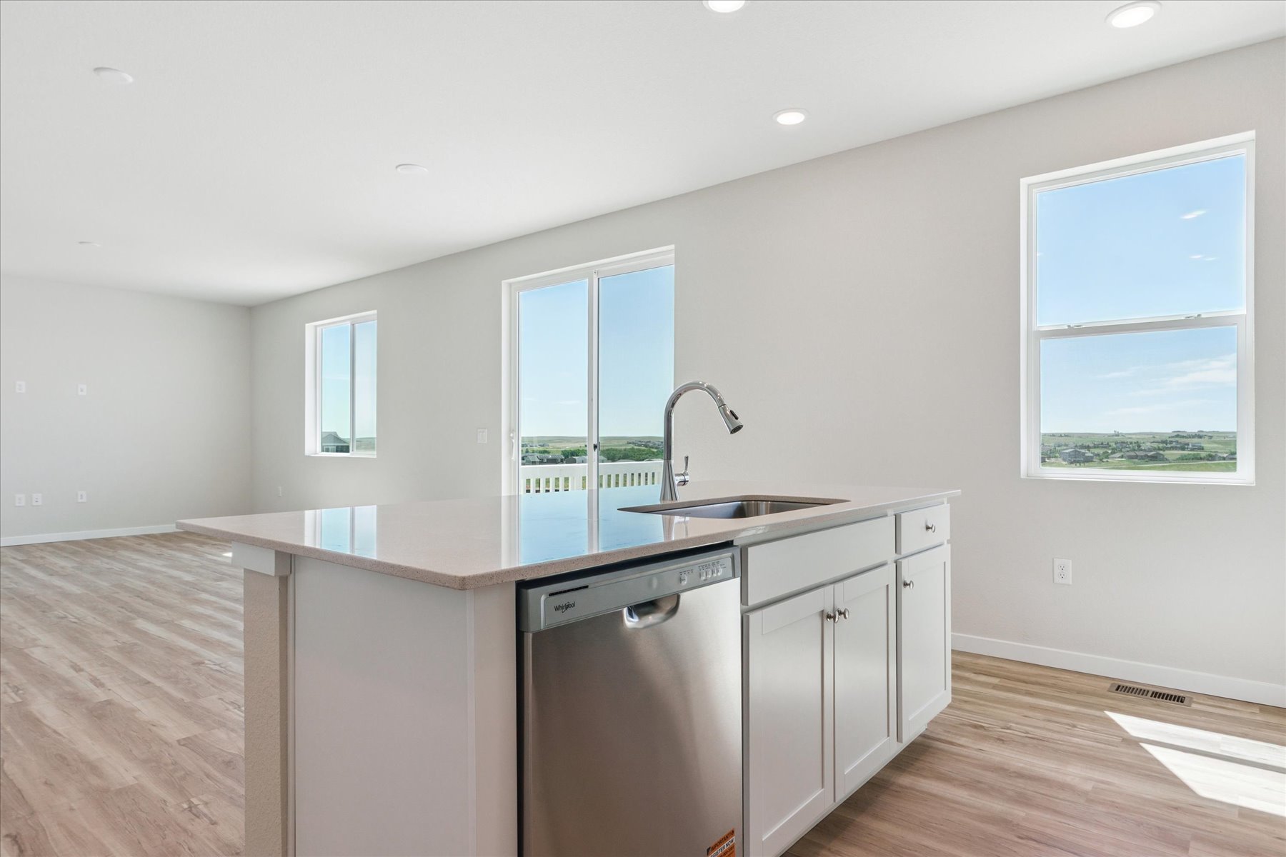 A kitchen with white cabinets.