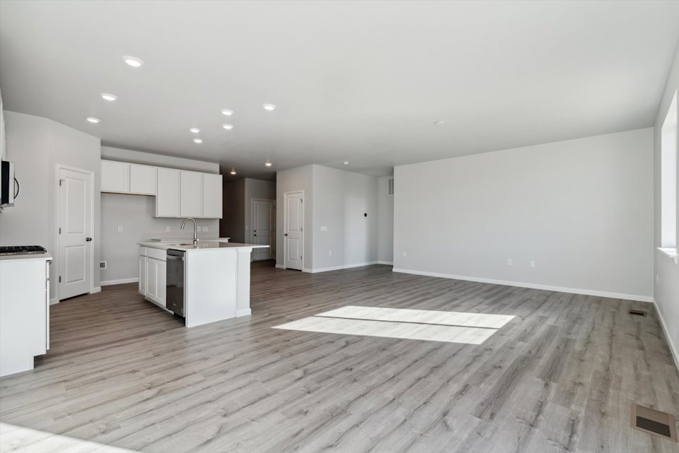 A large kitchen with white cabinets.