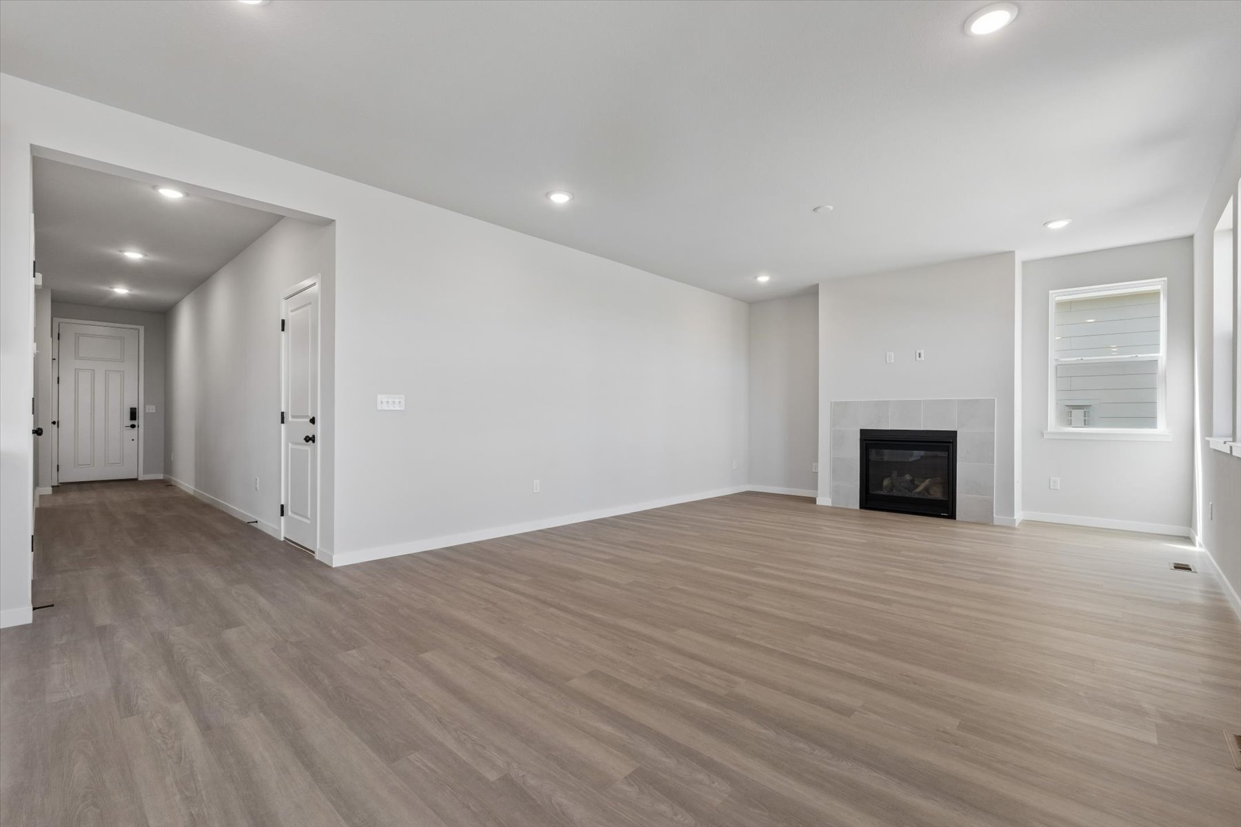 A large empty room with a fireplace.