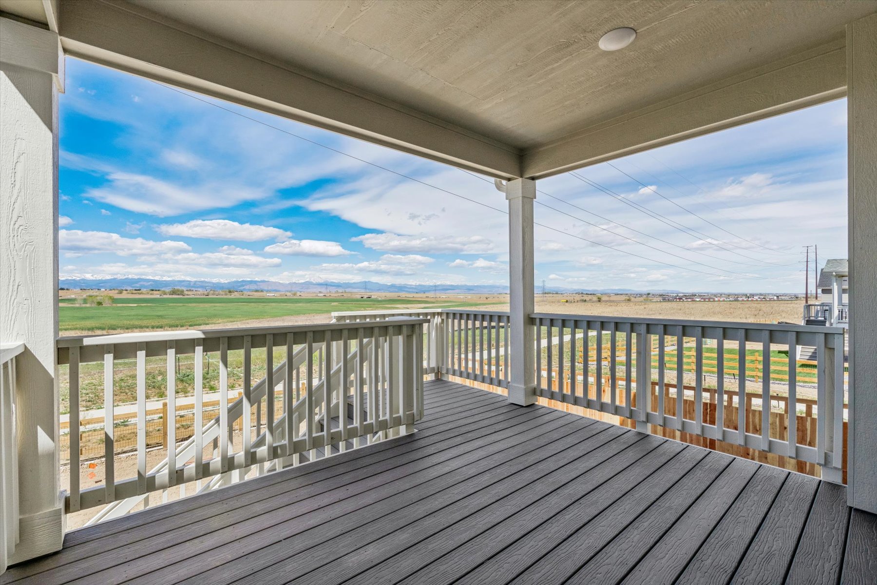 A deck with a view of the ocean and land.