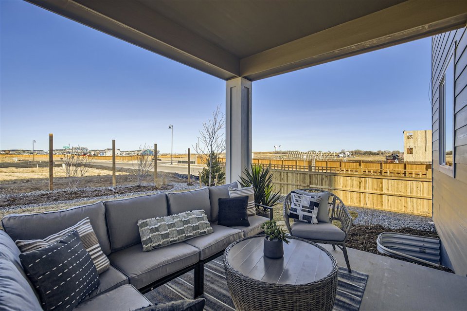 A patio with a table and chairs.