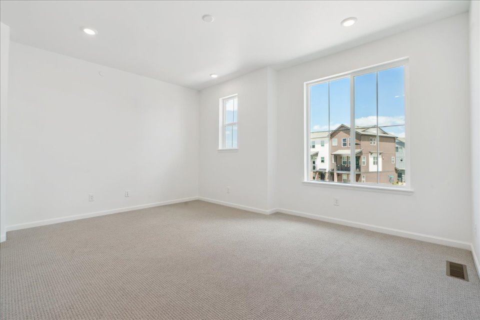 A room with a window and a carpet.