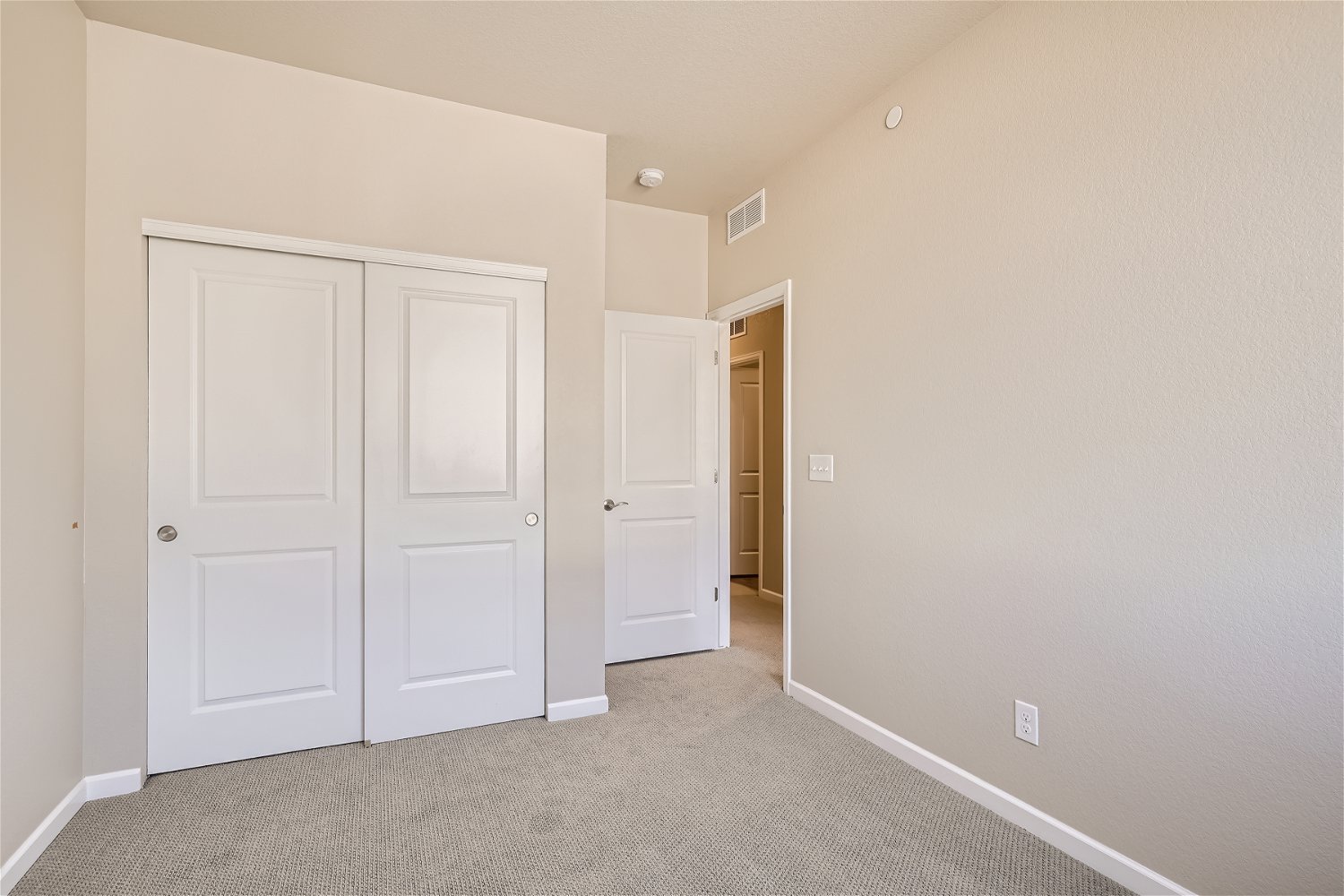 A hallway with white doors.